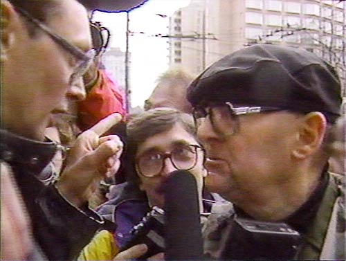 Black and white photo of Rick Gibson talking to protester