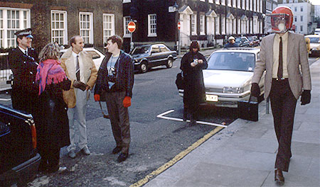 PICTURE: colour photo of people laughing while Rick Gibson walks back and forth with rat helmet